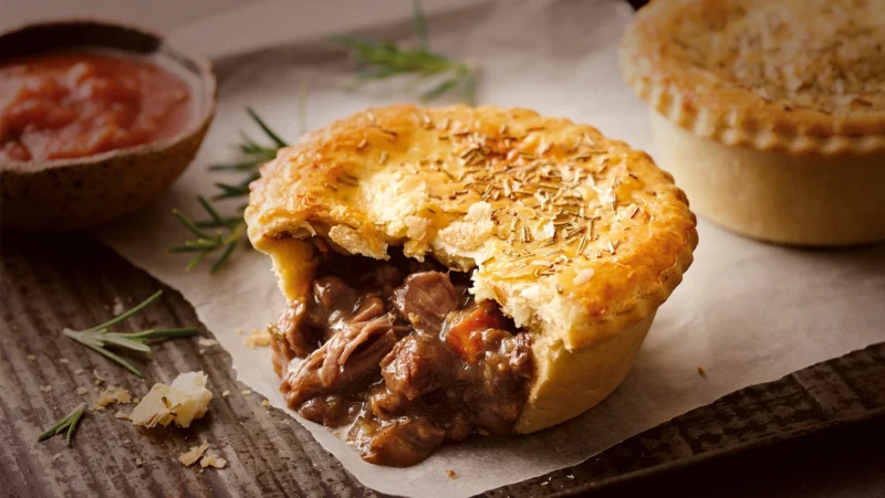New Zealand meat pie, homemade Austrie Meat Pie with savory beef filling and flaky pastry, traditional Kiwi comfort food australian cuisine world cuisine recipes aussie cuisine