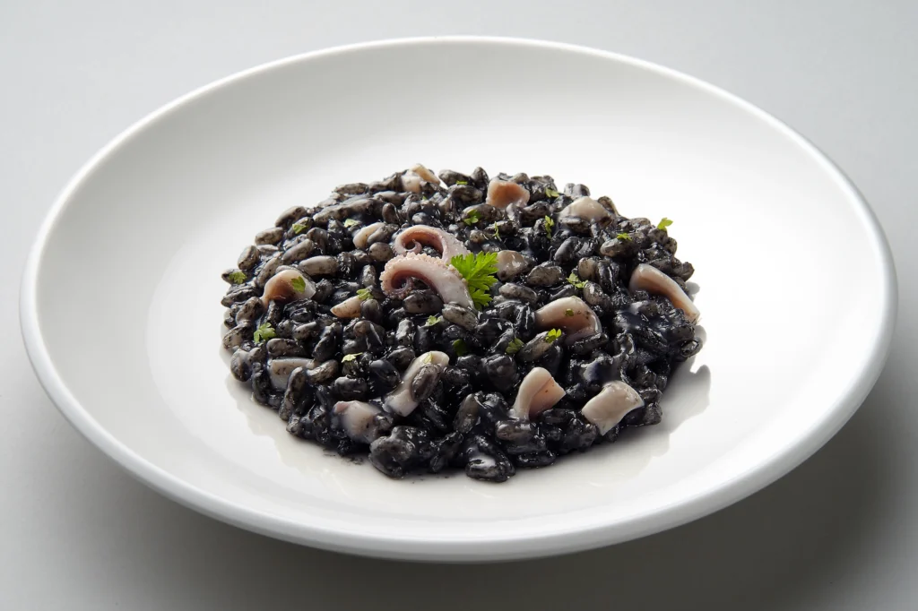 Crni rižot recipe, Croatian black risotto, How to make Crni rižot, Traditional Croatian seafood dish, Black rice risotto, Dalmatian coast cuisine, Crni rižot ingredients, Authentic Crni rižot, Best Crni rižot recipe, Seafood risotto with squid ink, pescetarian recipes