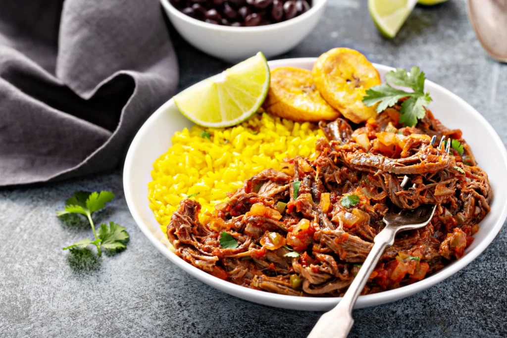 Authentic Cuban ropa vieja, Traditional Cuban stew, Ropa vieja recipe, Cuban shredded beef, Classic Caribbean cuisine, Cuban comfort food, Slow-cooked beef stew, Latin American culinary heritage, Savory shredded meat dish, Cuban family recipes