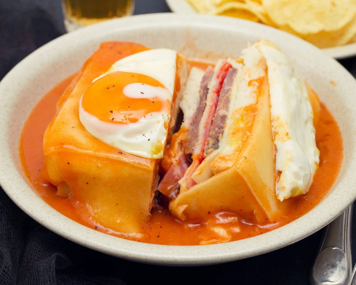 Authentic Portuguese Francesinha sandwich recipe Traditional Francesinha sandwich from Portugal How to make Francesinha sauce at home Classic Portuguese sandwich with ham and sausage Easy homemade Francesinha sandwich recipe